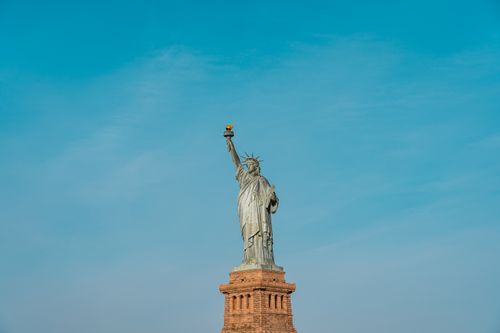 Free Iconic view of the Statue of Liberty against a clear blue sky in New York City. Stock Photo