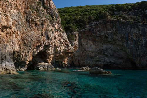 Free Explore tranquil coastal cliffs with crystal clear blue water, perfect for travel and nature lovers. Stock Photo