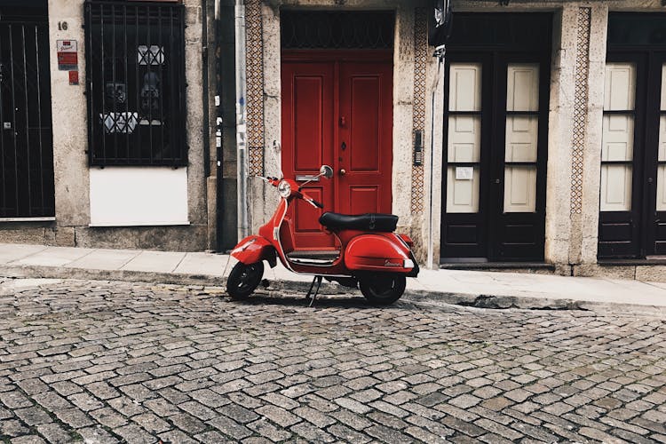 Red Motor Scooter Parked Beside Curb