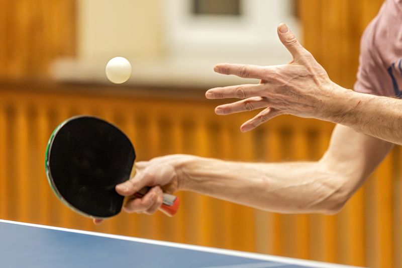 Table tennis player serving the ball