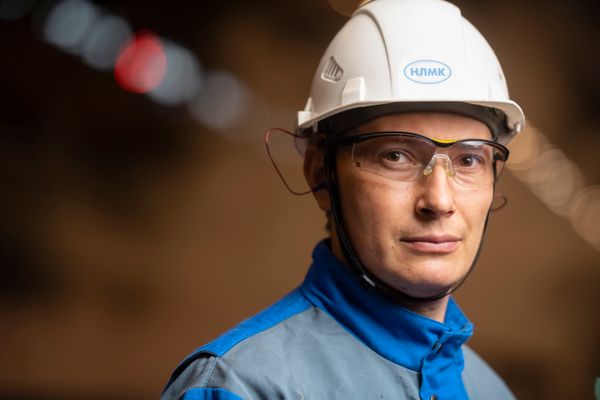 Engineer in safety helmet performing magnetic particle testing