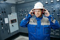 Engineer in Control Room with Safety Gear