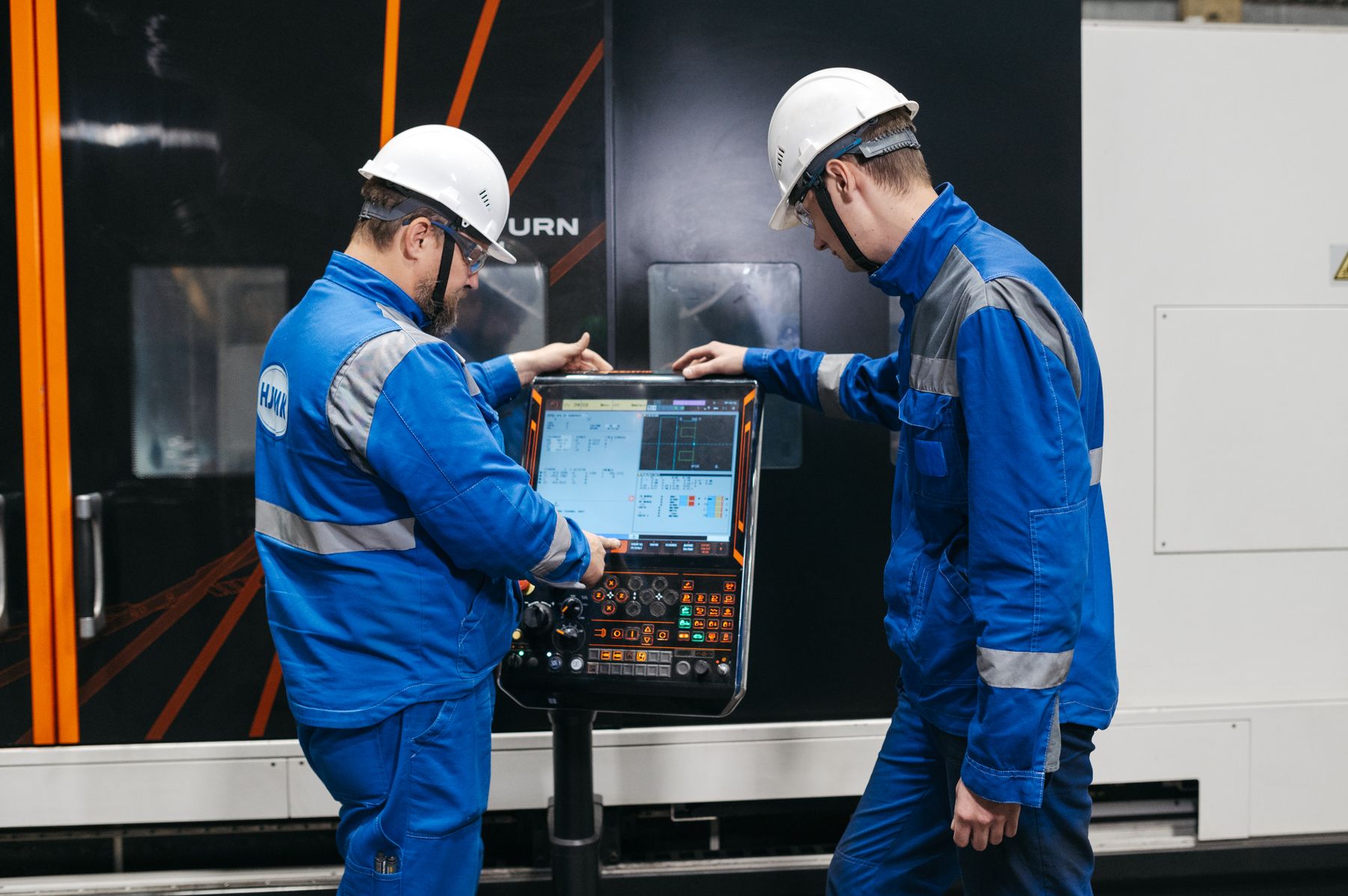 Engineers overseeing industrial equipment manufacturing
