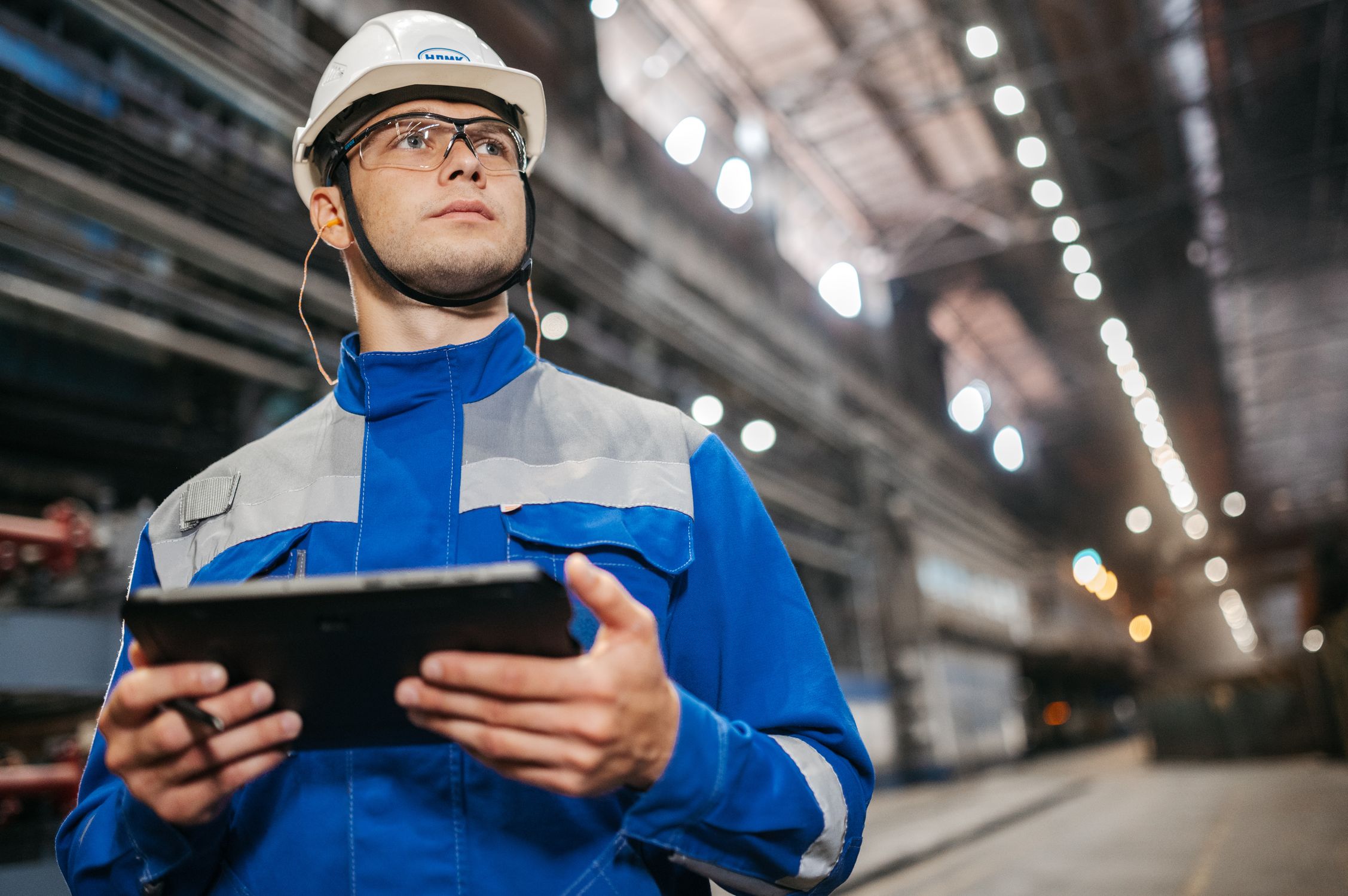 Industrial Worker Using Tablet in Factory · Free Stock Photo