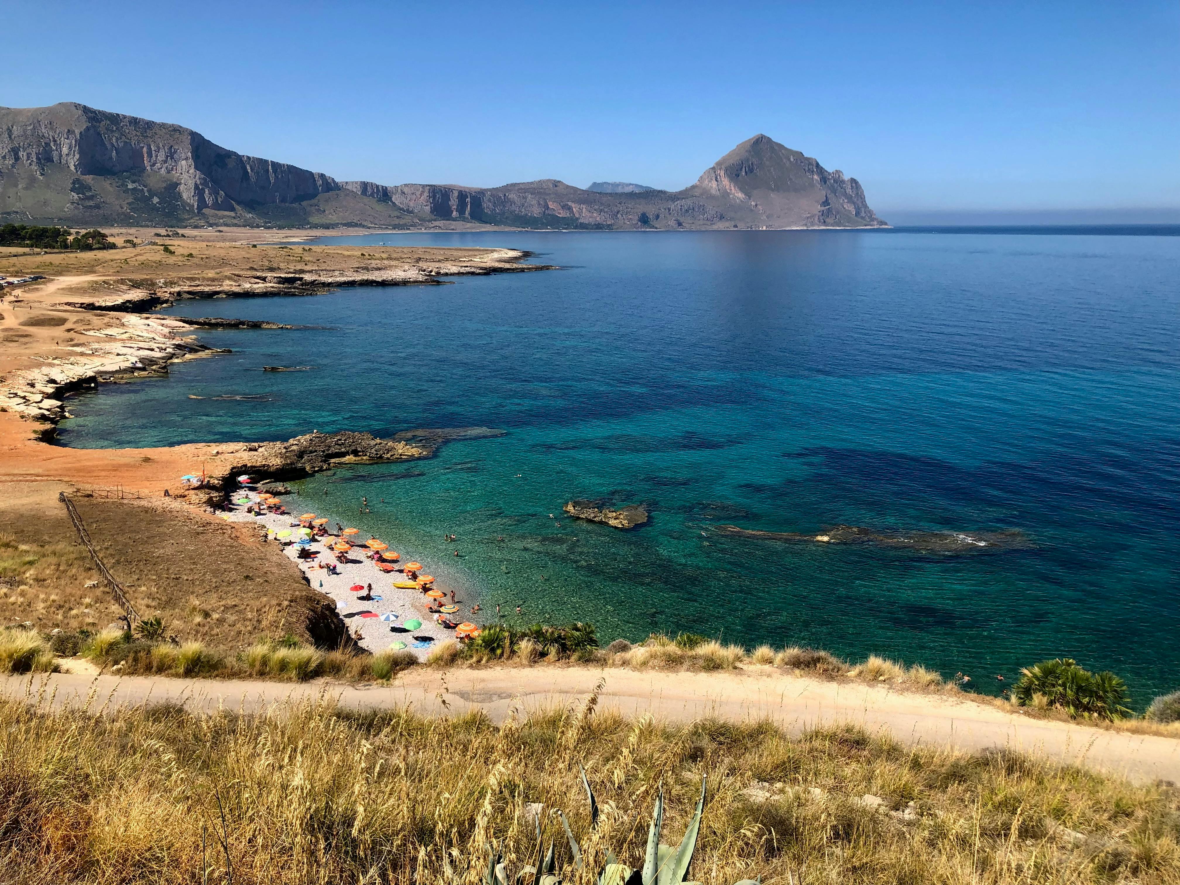 View from a hilltop medieval fortification over a Sicilian coastal town and turquoise sea