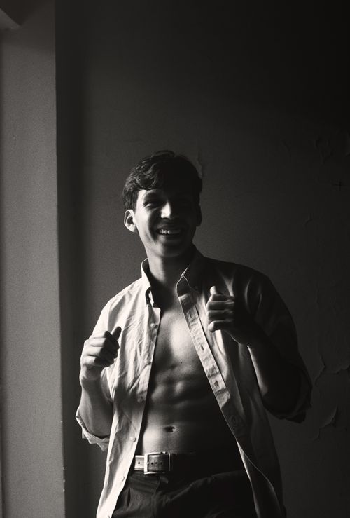 Free Black and white portrait of a smiling man in casual wear, showcasing confident and relaxed mood. Stock Photo