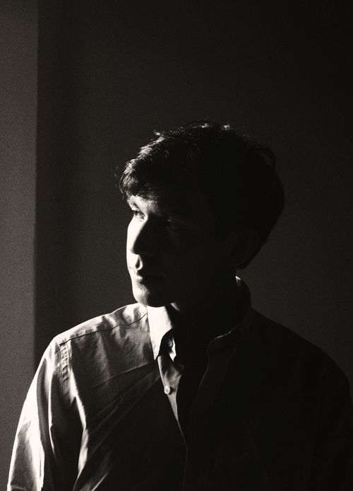 Free Captivating black and white portrait of a man in dramatic light and shadow. Stock Photo