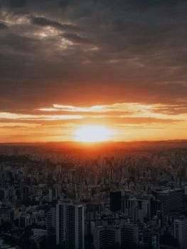 Breathtaking aerial view of Belo Horizonte during golden hour with a vibrant sunset.