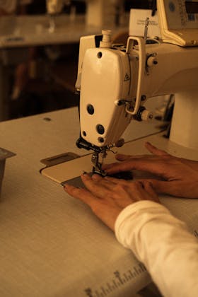 Hands sewing on industrial machine