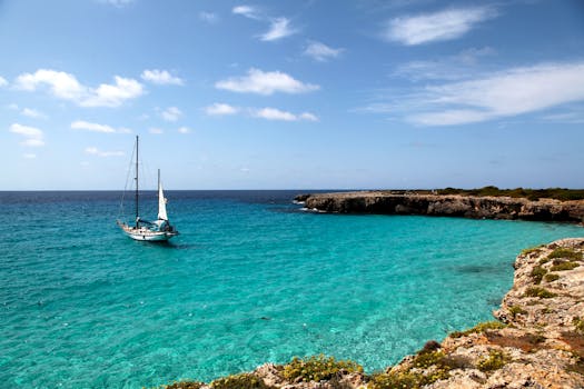 Serene coastal view of a sailing boat in Ciudadela de Menorca, Spain.