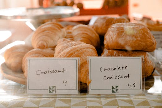 Delicious croissants and chocolate croissants elegantly displayed at a bakery.