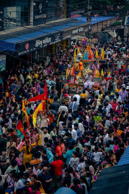 Free Vibrant street scene of Rath Yatra festival in Odisha with colorful chariots and crowds celebrating. Stock Photo