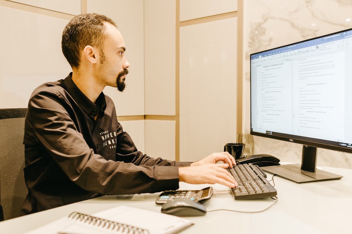 Free Man Typing on Computer Keyboard Stock Photo