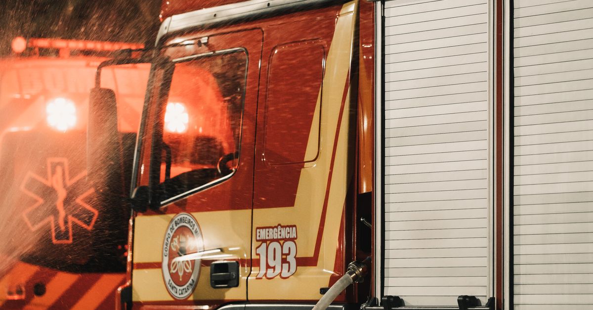 Fire Service Using Teamwork Firefighter teamwork at night emergency scene · Free Stock Photo