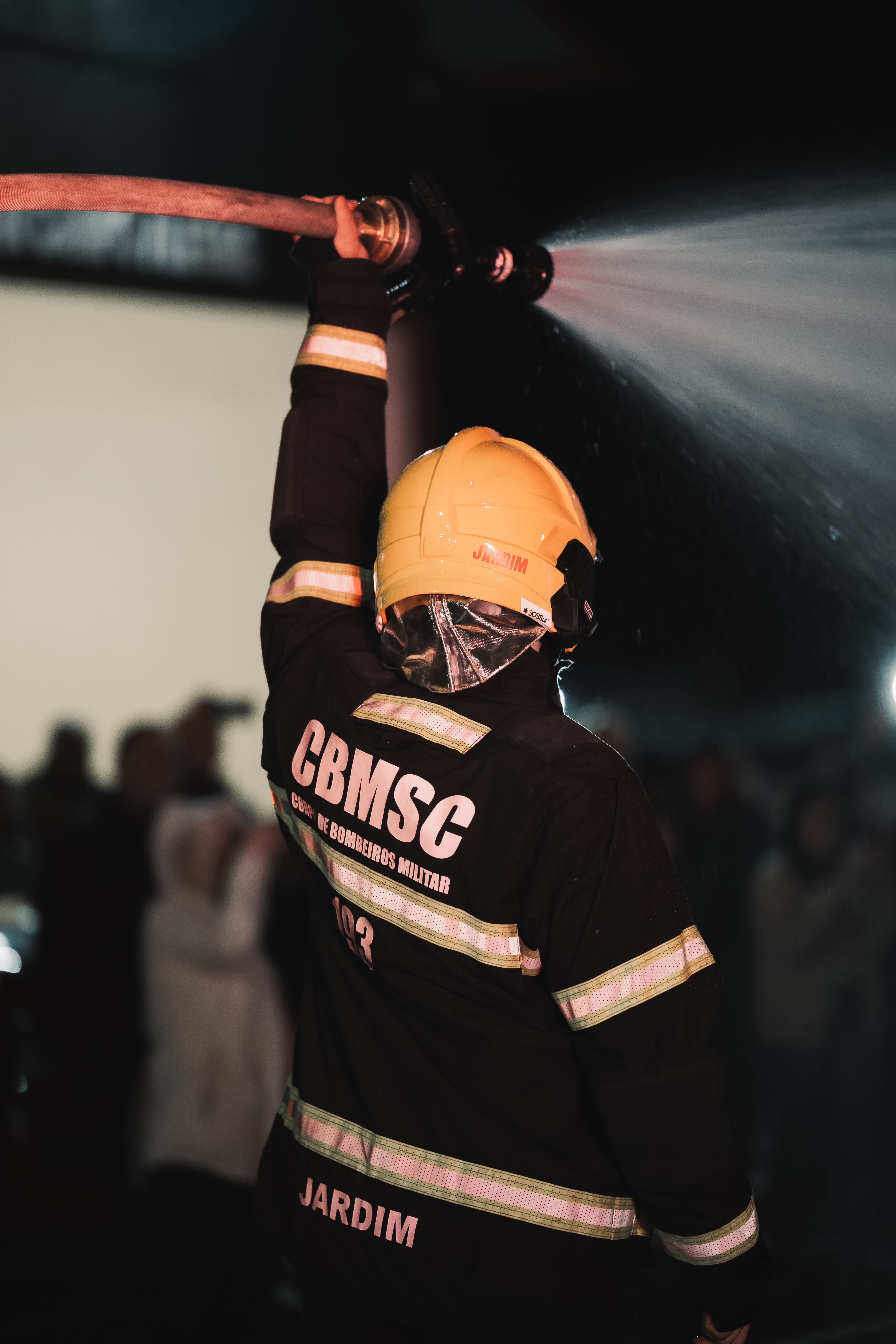 Fireman Holding Fire Hose · Free Stock Photo