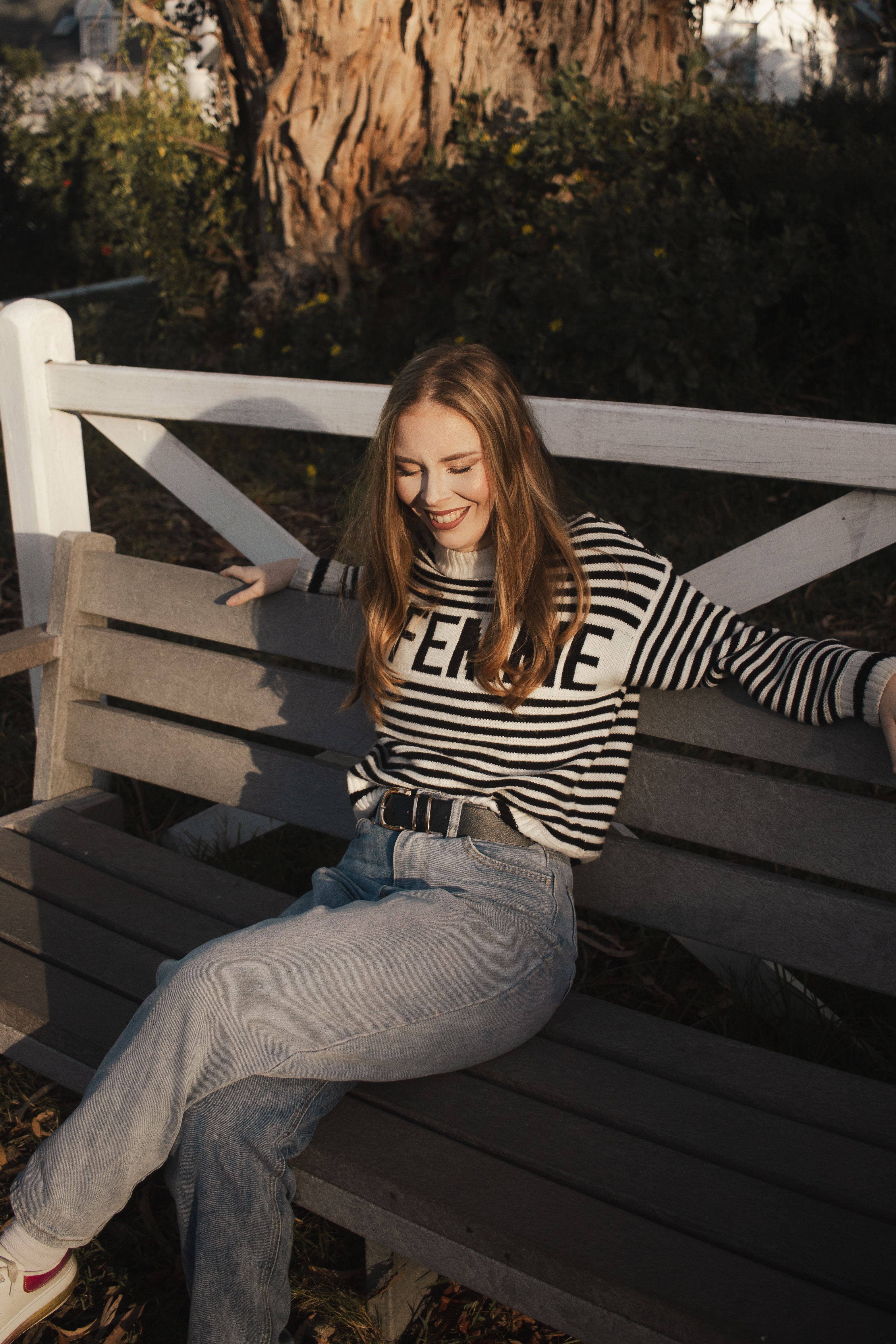 Woman in white jeans with striped sweater