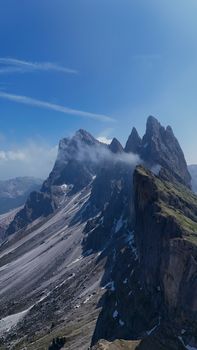 Breathtaking panoramic view of the Seceda peaks in the Dolomites under a clear blue sky.