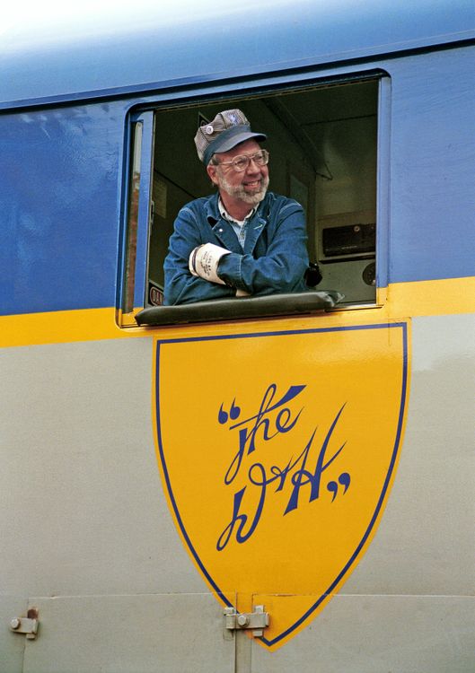 Smiling Train Driver Friendly Train Engineer Smiling from Locomotive Cab · Free Stock Photo