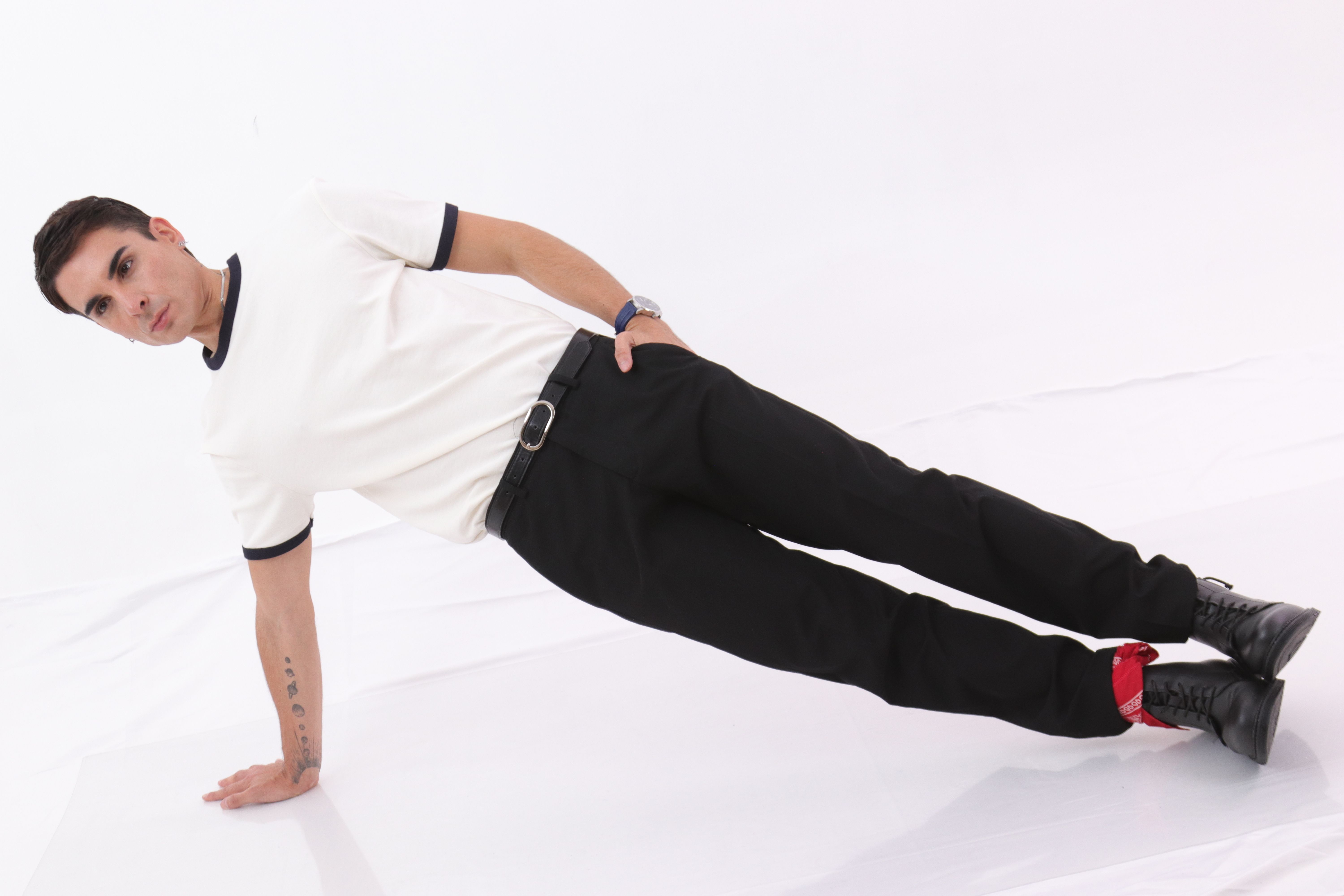 Man Balancing in Unique Pose on White Background · Free Stock Photo