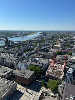 Aerial shot of Cologne, Germany featuring the Rhine River and city landmarks.