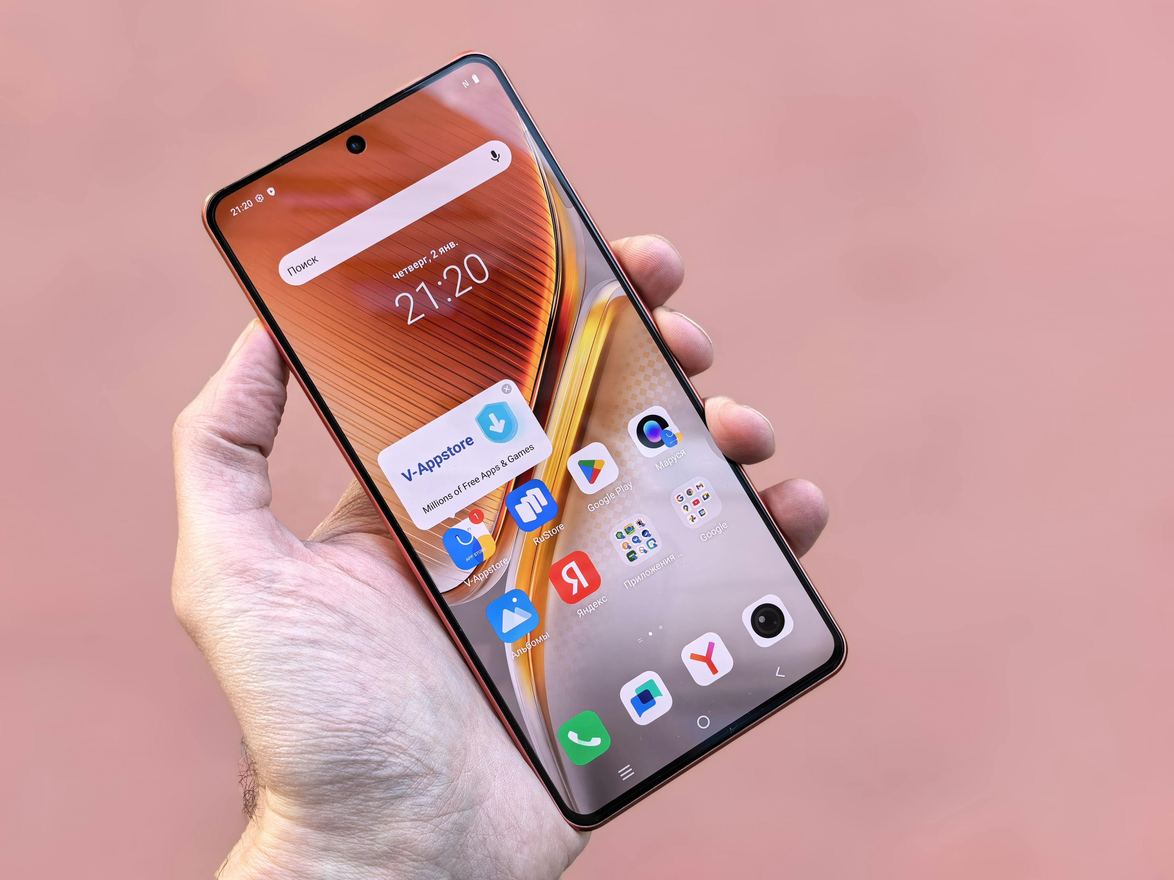 Free A person holding a smartphone displaying various apps on a pink background. Ideal for technology themes. Stock Photo