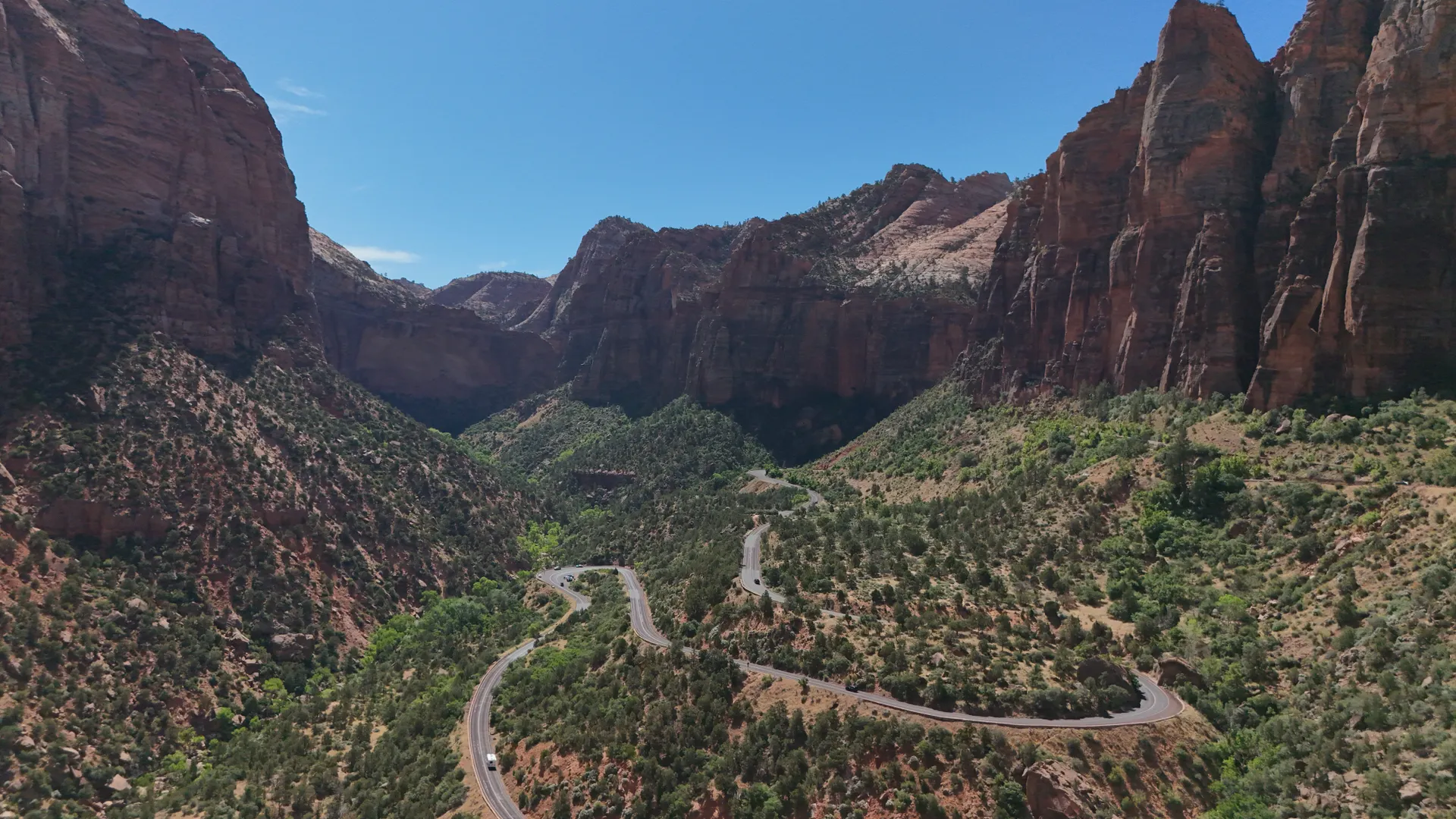 Aerial view of winding road through Zion National Park's red rock formations in Utah. Aerial view of winding road through Zion National Park's red rock formations in Utah.