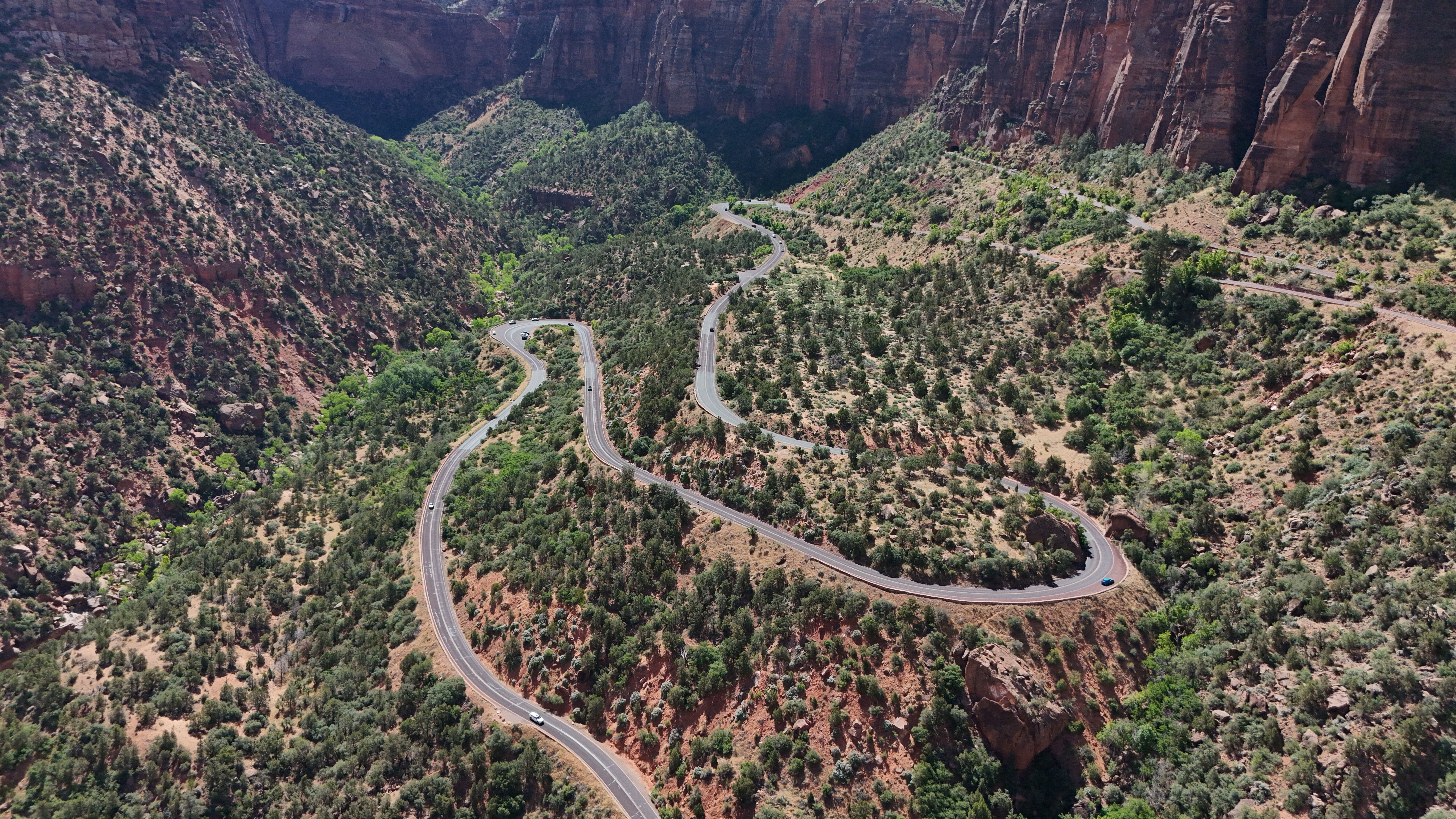 Breathtaking 35 Mile - Zion National Park Panoramic Helicopter Flight Review 2026 - Aerial view of a winding road through the red rock canyons of Zion National Park, Utah.