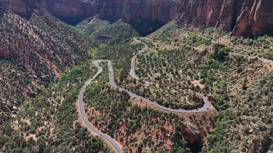 Breathtaking 35 Mile - Zion National Park Panoramic Helicopter Flight Review 2026 - Aerial view of a winding road through the red rock canyons of Zion National Park, Utah.