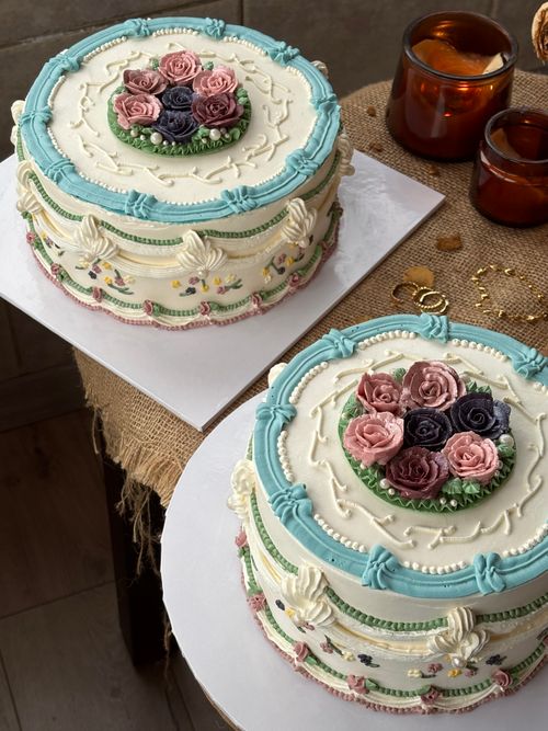 Free Two intricately designed cakes with floral icing and pastel colors displayed elegantly. Stock Photo