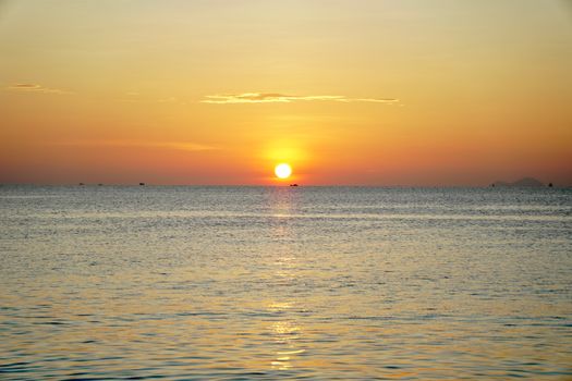 Peaceful sunrise over a calm ocean with a golden horizon, perfect for tranquil moments.