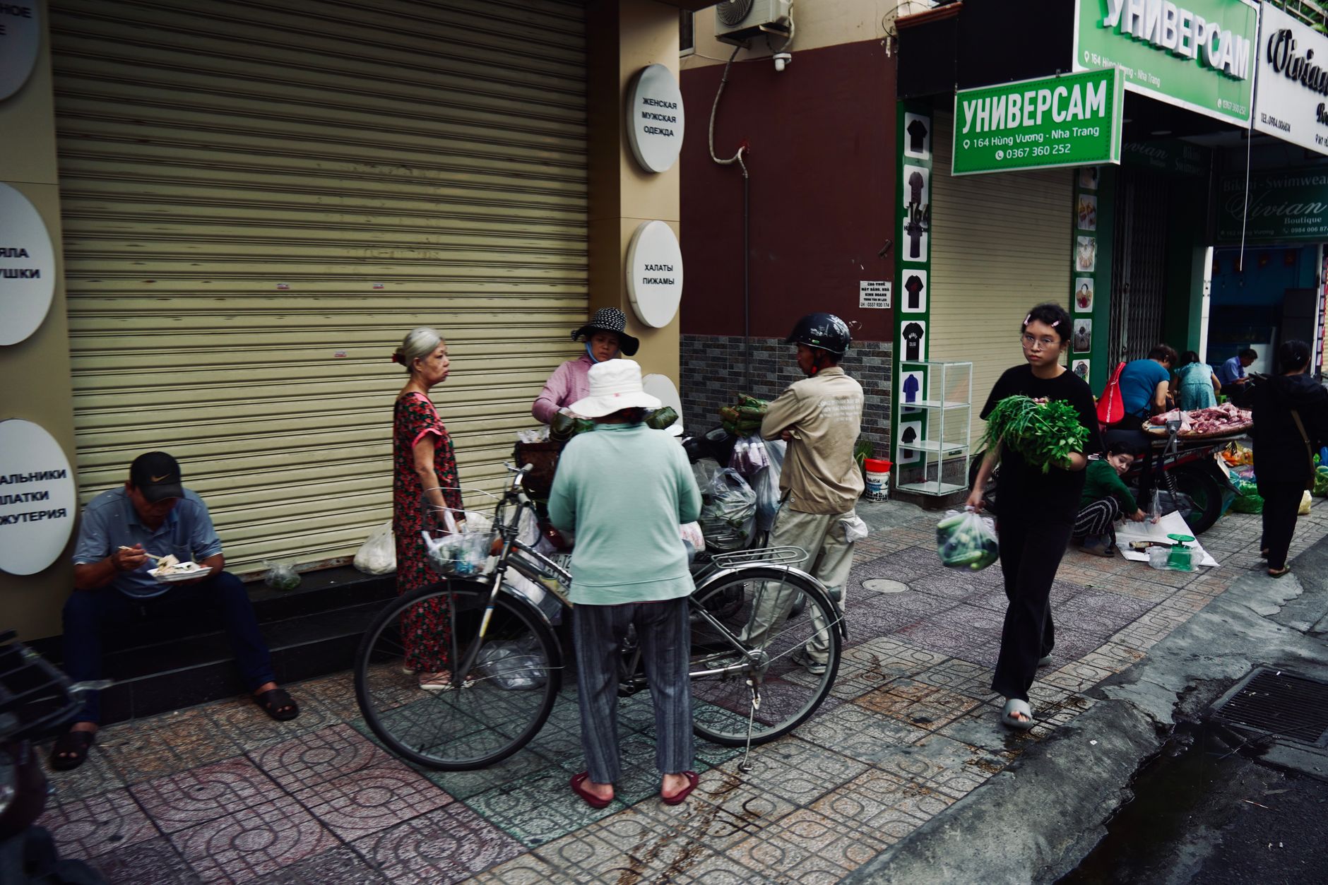 Vibrant street market in Nha Trang, Vietnam with people and fresh produce.