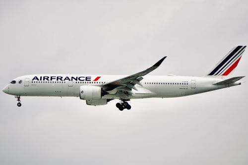 Free Side view of Air France Airbus A350-900 aircraft flying against a cloudy sky. Stock Photo