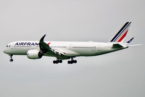 Free Air France Airbus A350 aircraft captured mid-flight with a clear sky background. Stock Photo