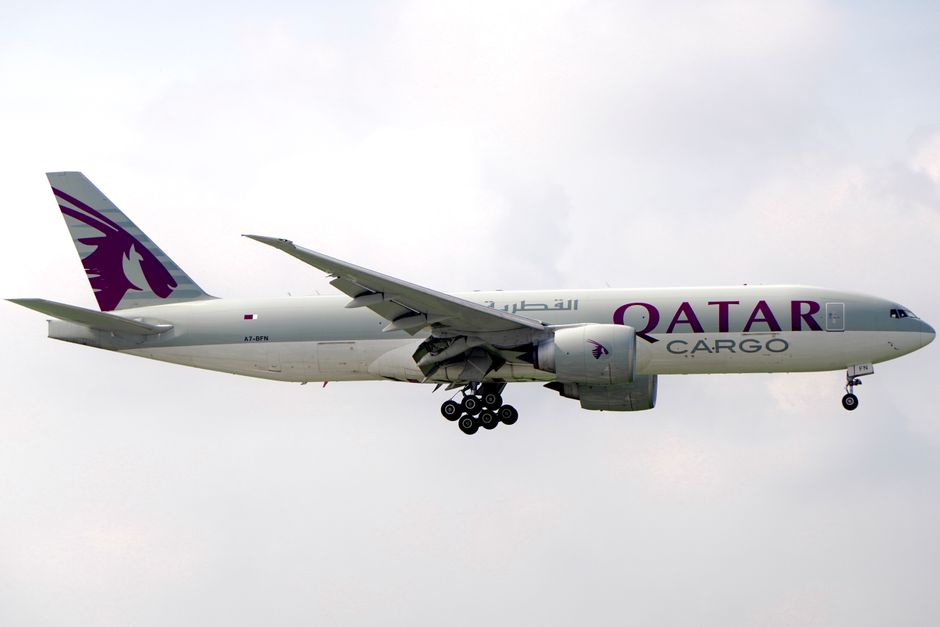 Qatar Cargo airplane captured flying against a cloudy backdrop, showcasing aviation in action.