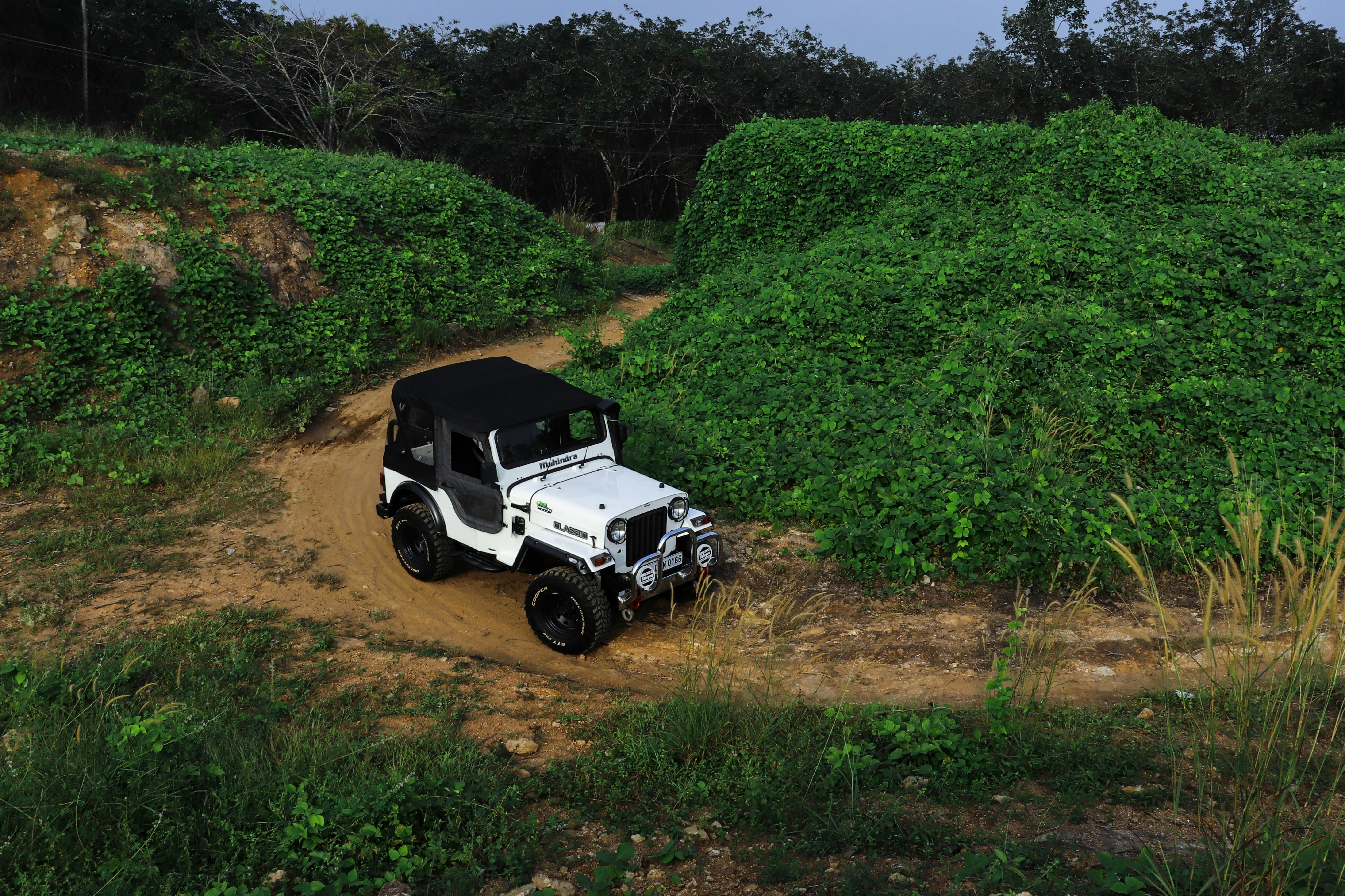 A rugged 4x4 vehicle exploring lush offroad trails in Kerala's scenic nature.