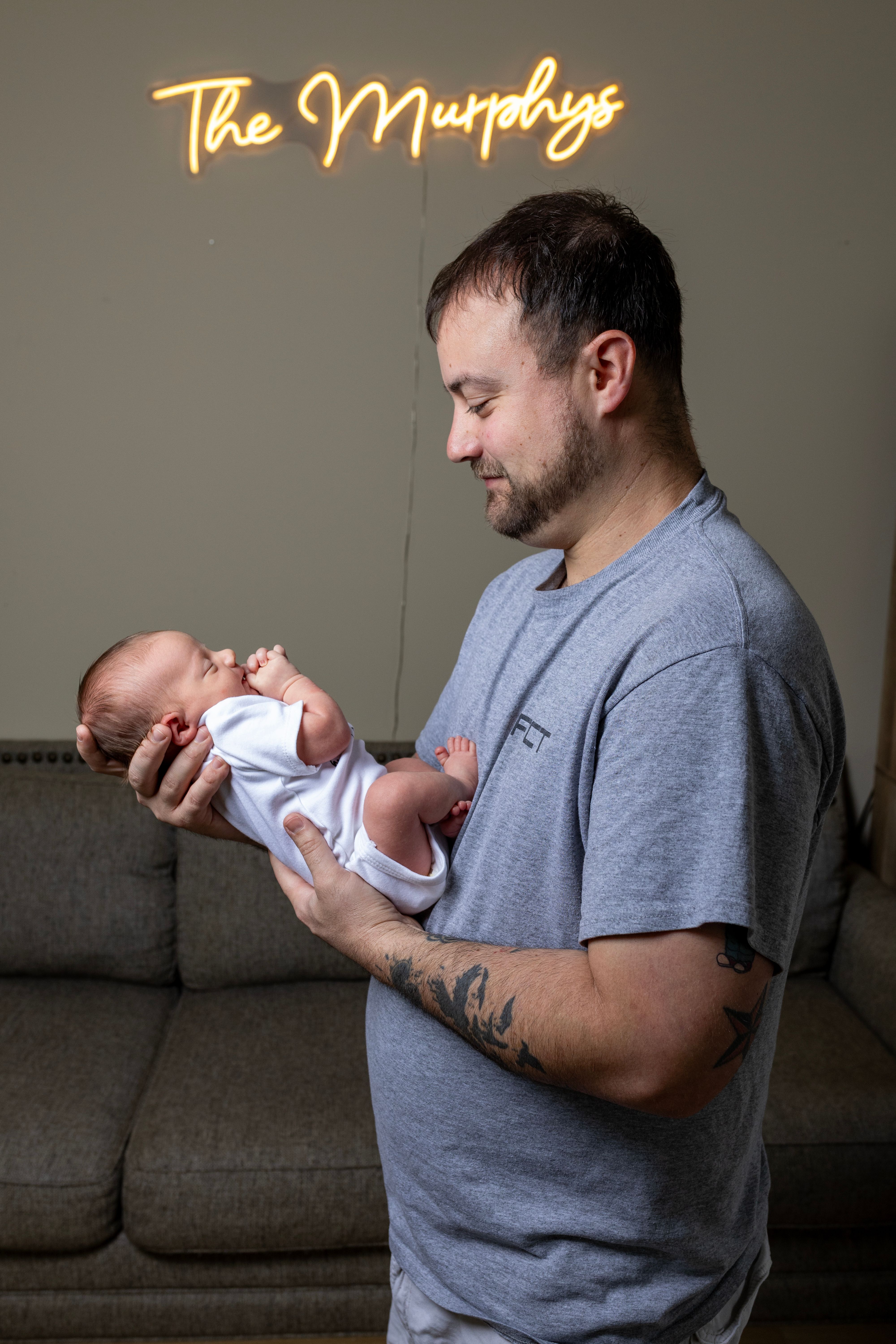 father holding newborn baby home