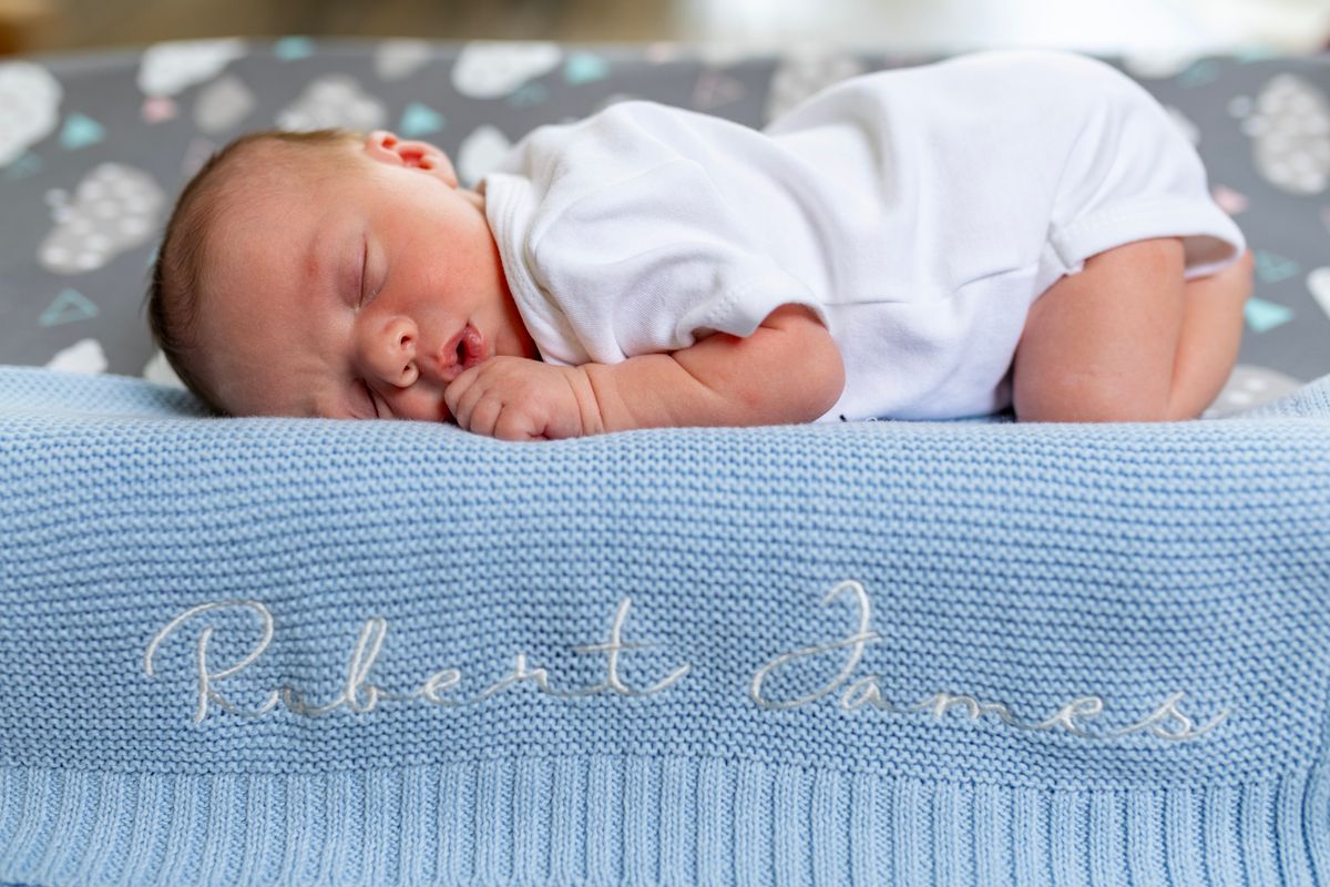 Baby asleep on a name blanket