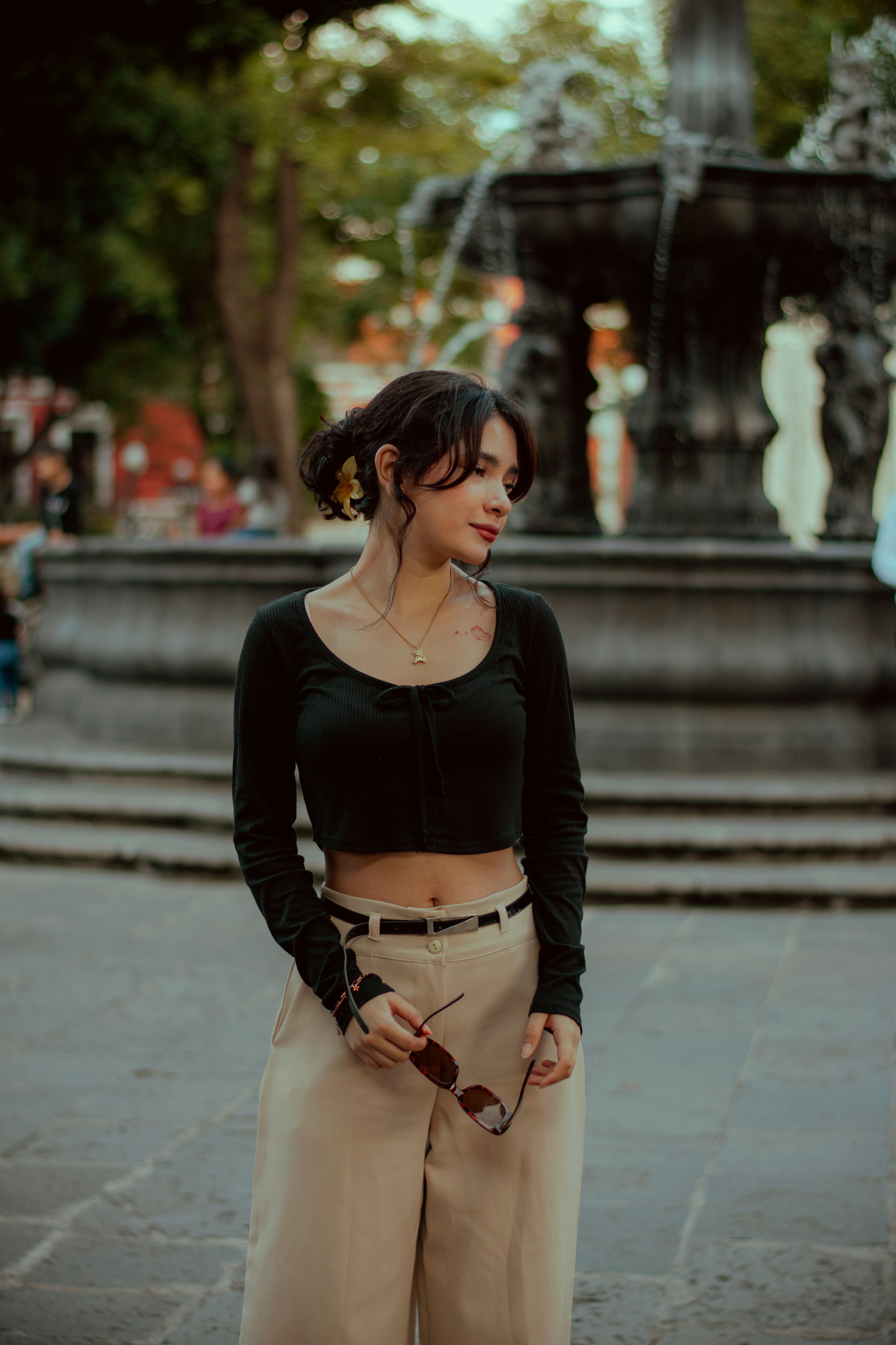 Stylish Woman Posing by Fountain in Urban Park · Free Stock Photo