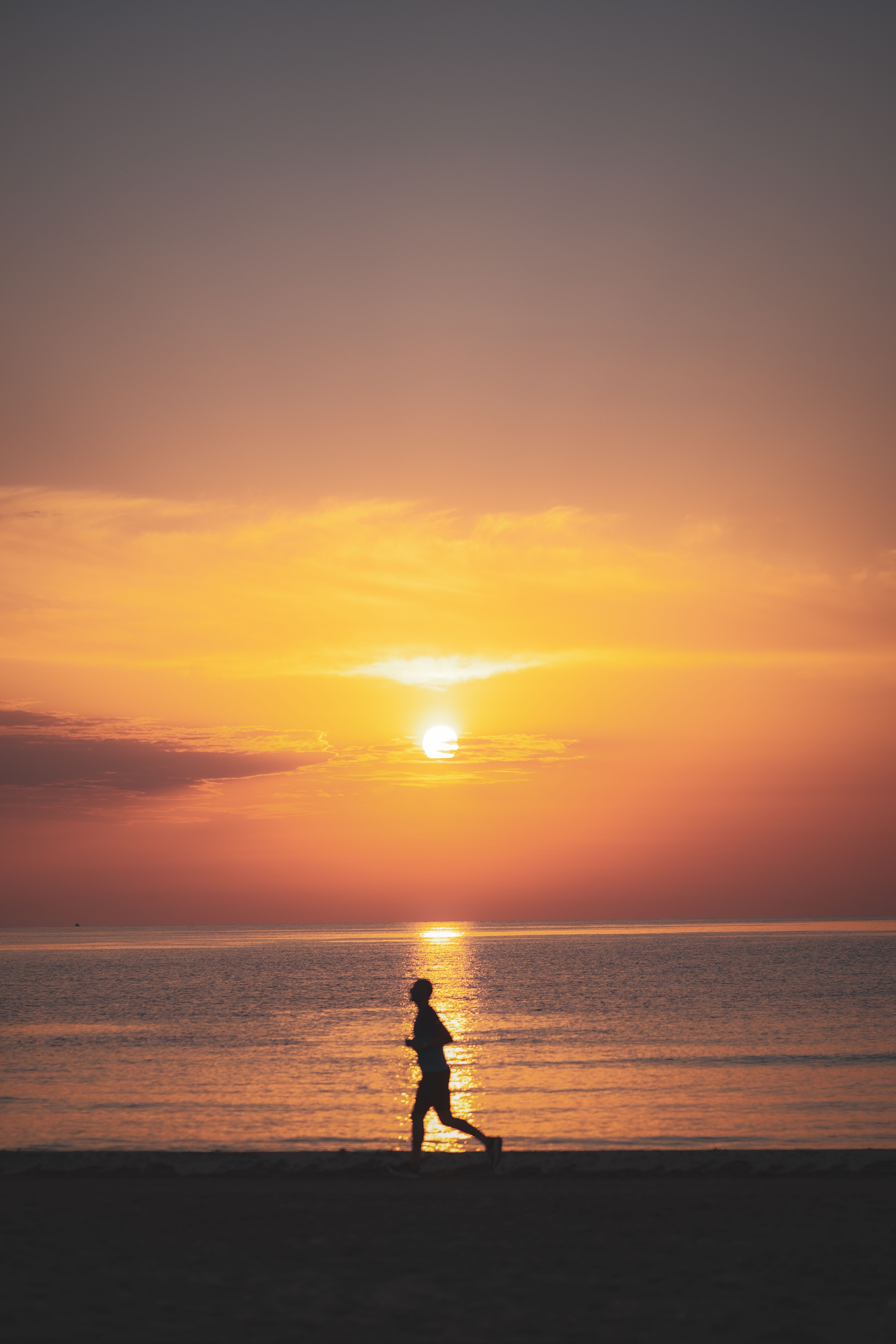 Silhouette of Person Jogging at Beach Sunset · Free Stock Photo