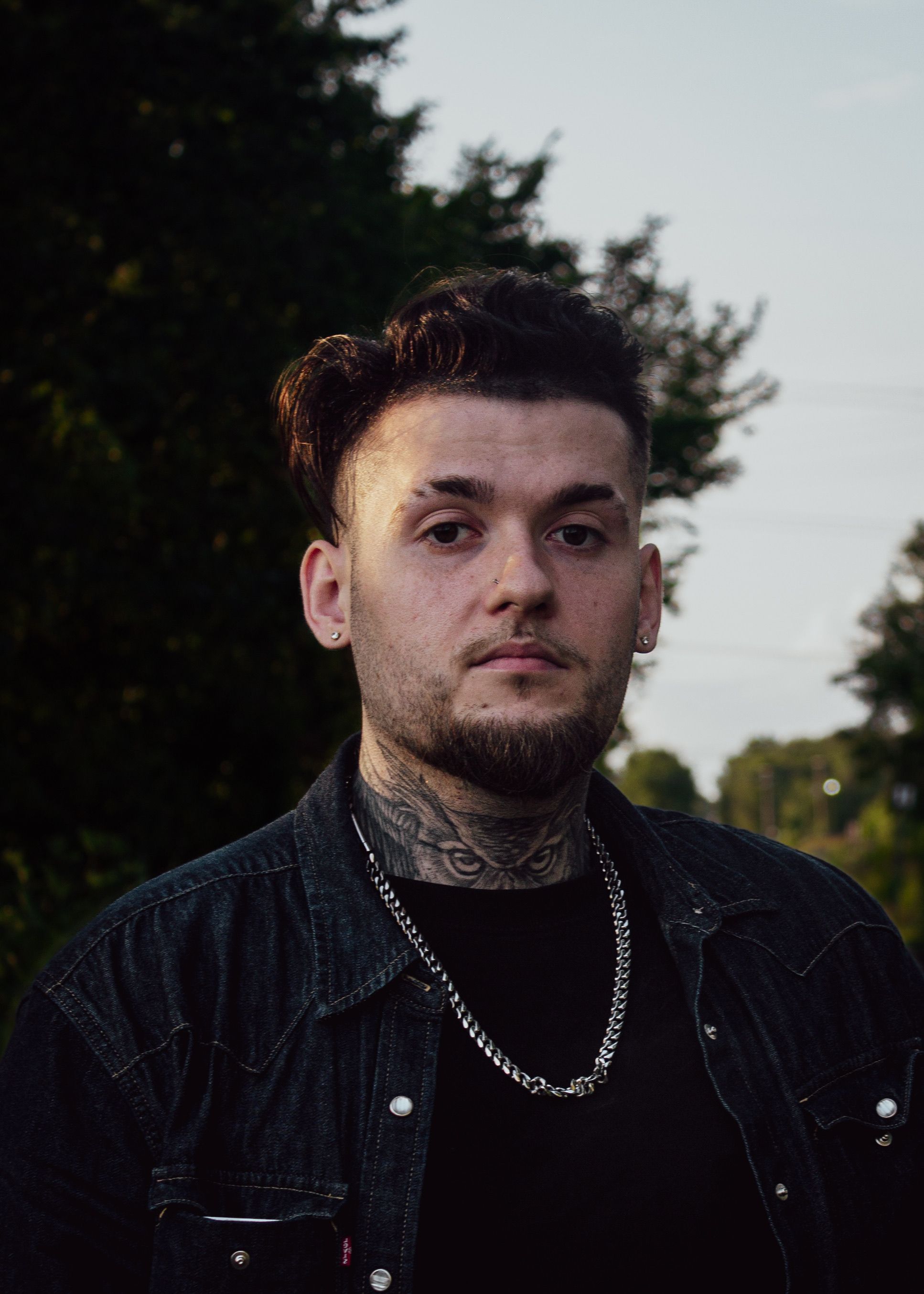 Portrait of a tattooed man outdoors in Montreal during the day.
