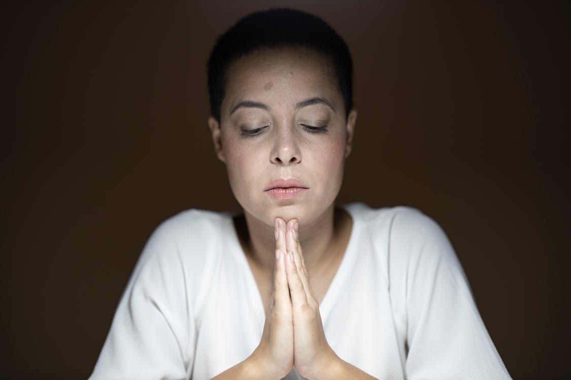 Free Woman Wearing White Long-sleeved Shirt Prayng Stock Photo
