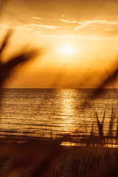 Stunning golden sunset over the sea at Middelkerke, Belgium casting reflections on calm waters.
