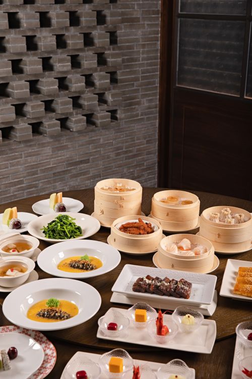 Free A variety of Chinese dishes including dim sum on a beautifully arranged dining table. Stock Photo