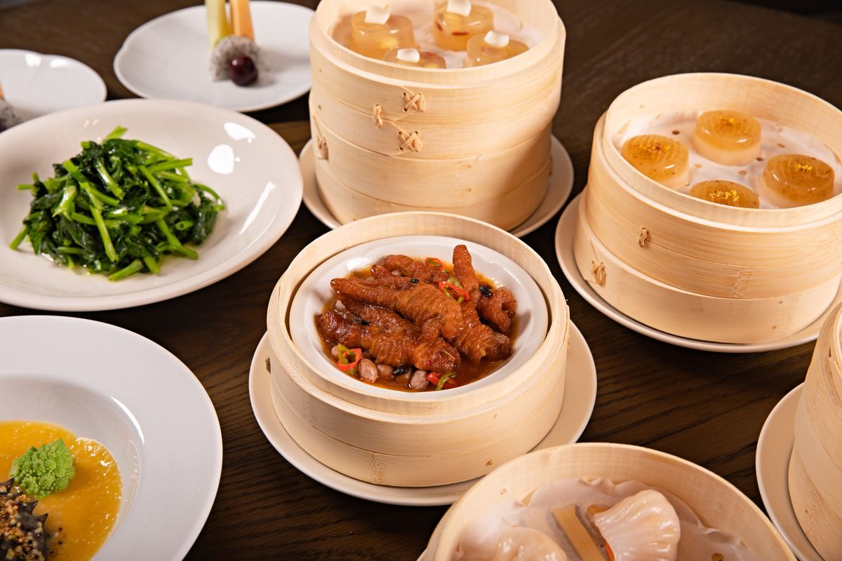 A tantalizing spread of dim sum dishes served in traditional bamboo steamers with a variety of appetizers.