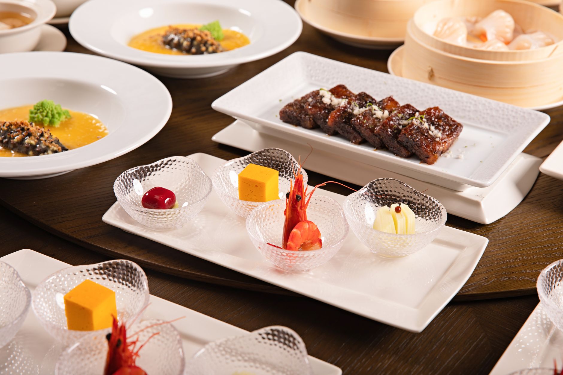 A luxurious spread of gourmet dishes featuring seafood and fine dining elements.