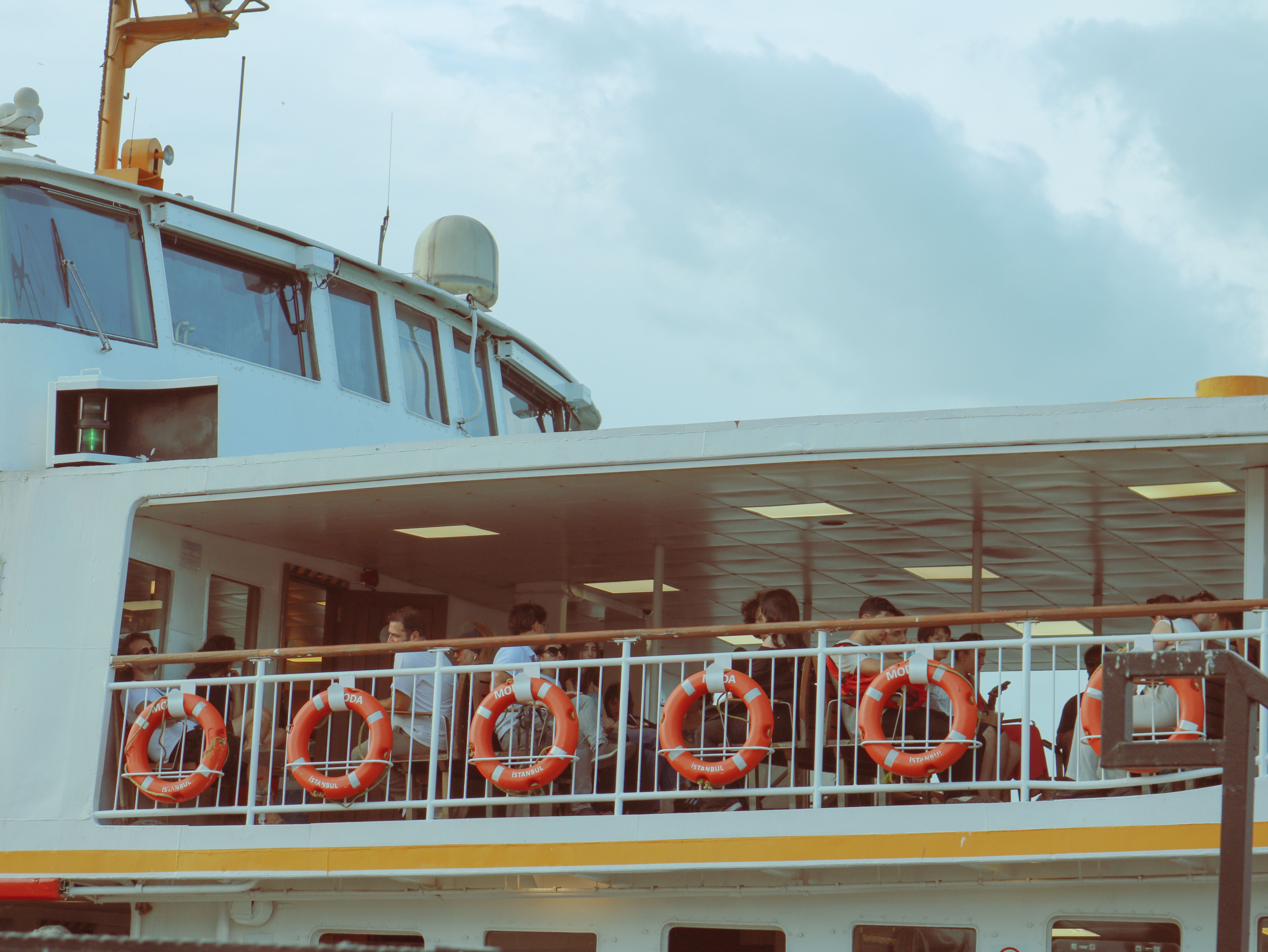 Passengers Relaxing on a Ferry's Upper Deck · Free Stock Photo