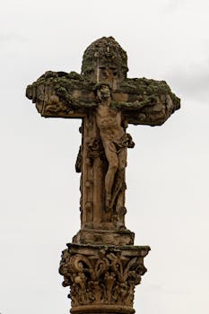 Detailed view of an ancient stone crucifix in Salamanca, showcasing intricate designs and historic craftsmanship.