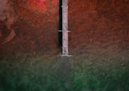 Aerial View of Pier Over Vibrant Waters in Sweden