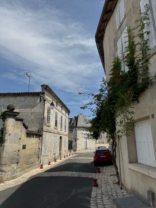 Free Quaint European village street with stone houses and blue sky. Explore history and architecture. Stock Photo