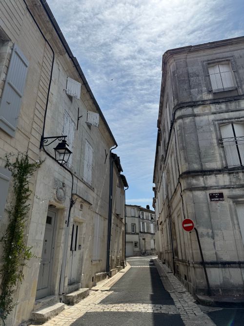 Free Serene stone street with classic architecture under a bright sky. Stock Photo